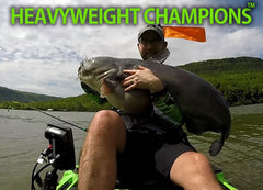 man in kayak holding very large catfish